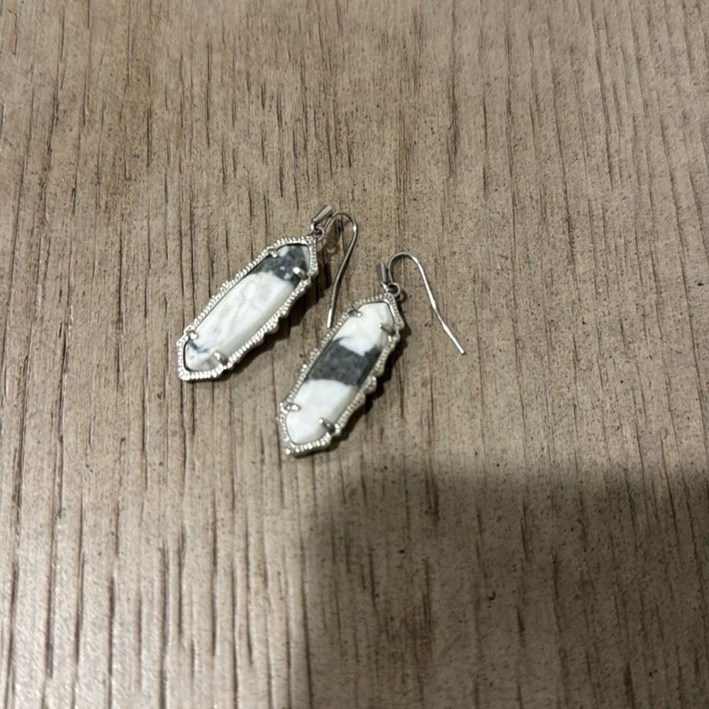 White and gray Kendra Scott  earrings wrapped in silver.